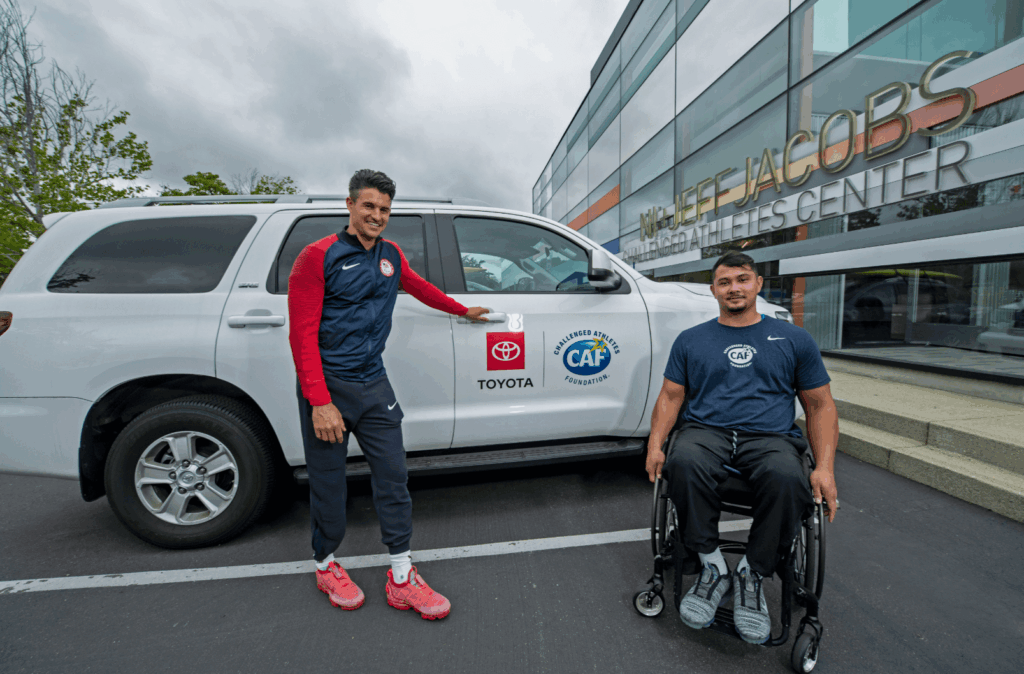 Justin Phongsavanah and Trenten Merril in front of Toyota SUV at CAF building