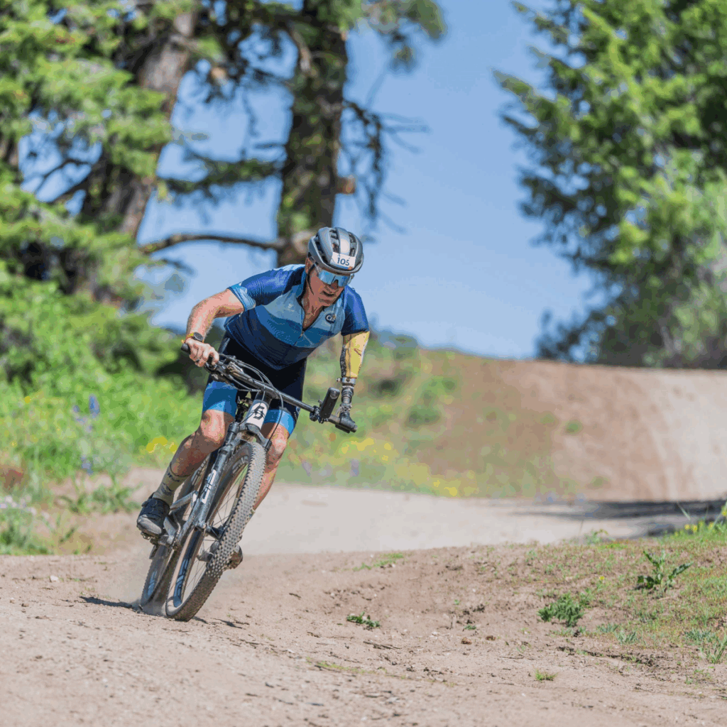 Willie Stewart riding a mountain bike with a prosthesis on one arm