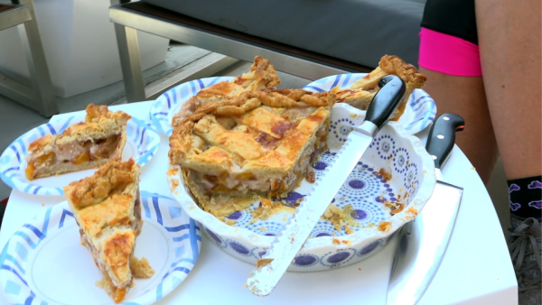 Close-up of a homemade pie with several slices cut, ready to be shared after a group ride.