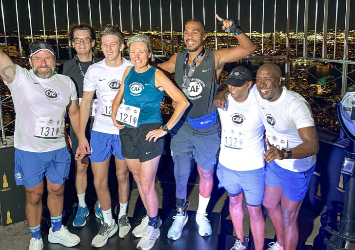 Team of CAF athletes celebrates together at the top of the Empire State Building after completing the Run-Up.