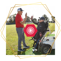Athlete with a physical disability participating in an adaptive golf clinic with support staff nearby